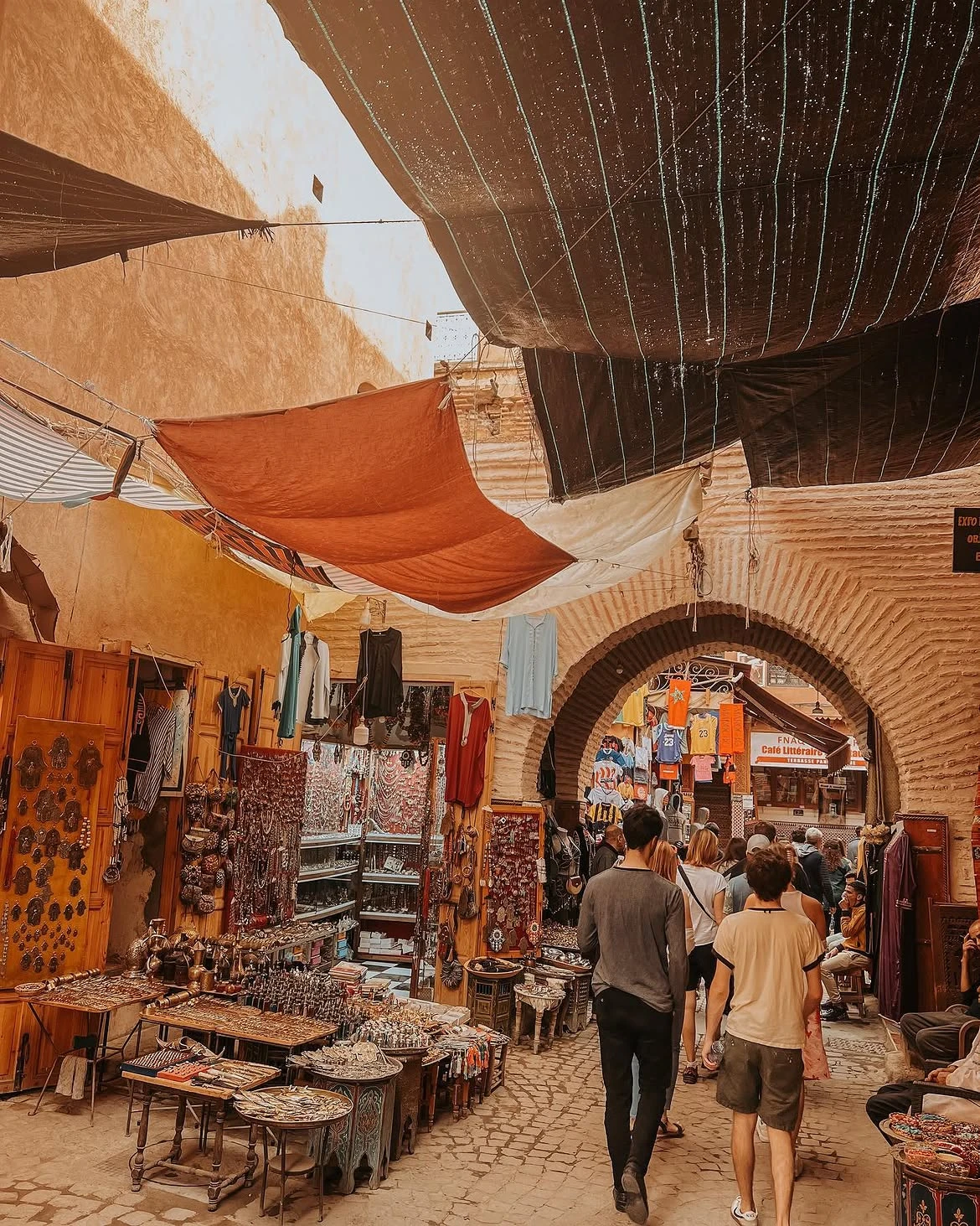 Tourist walking independently through a Marrakech medina alley without a tour guide